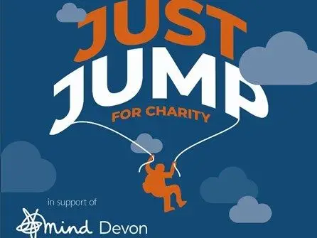 Just Jump for Charity promotional graphic featuring a skydiver illustration with clouds, supporting Mind Devon mental health charity