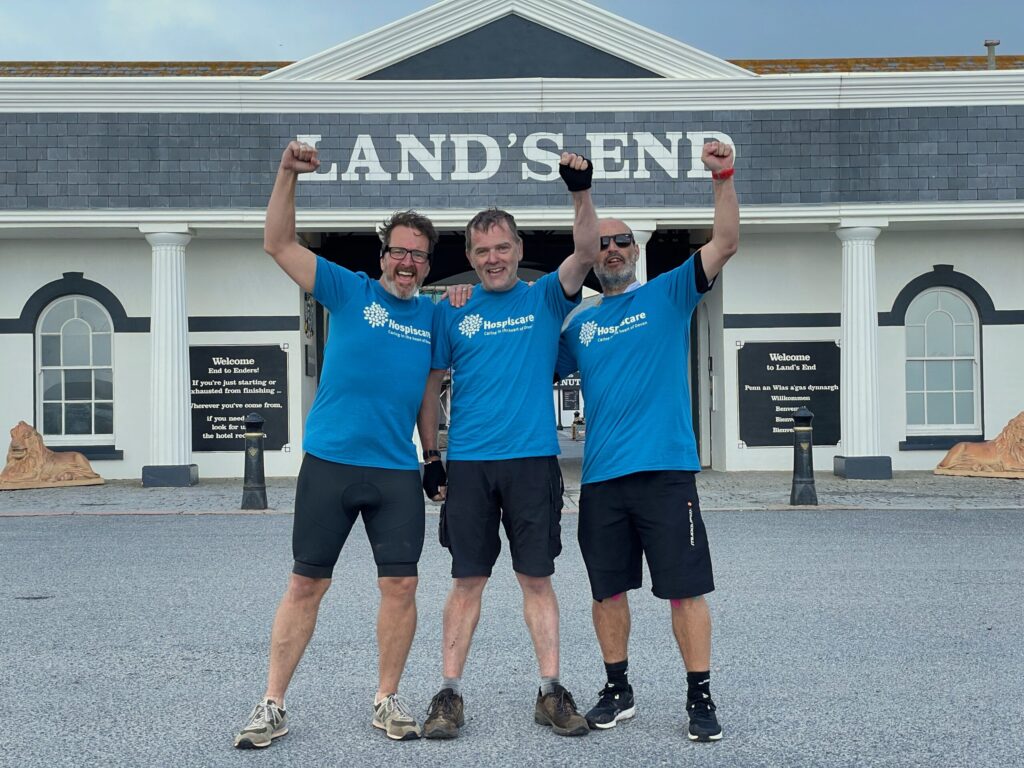 three men in blue shirts at Land's End