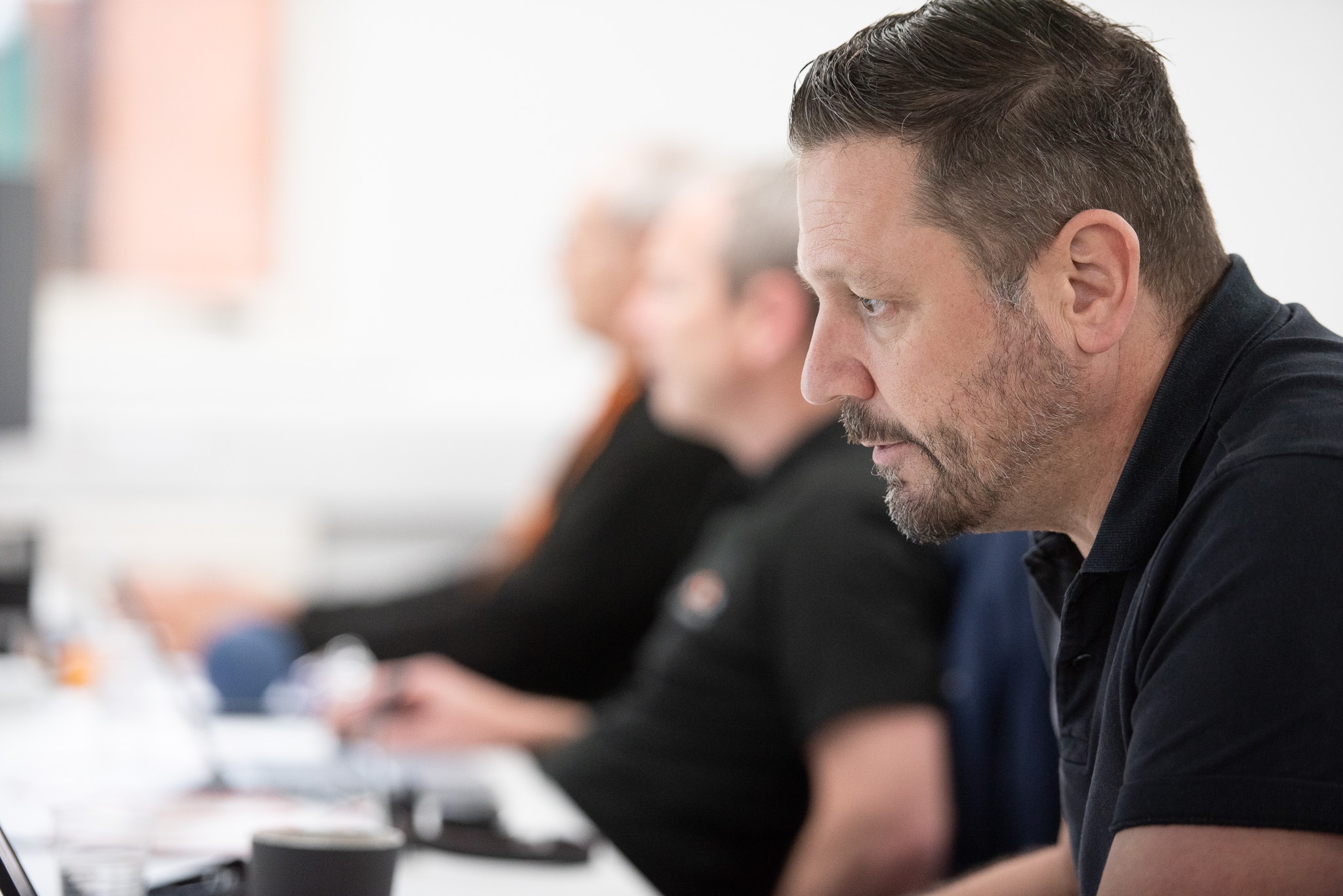 Nexus IT professional concentrating during a team meeting in the office