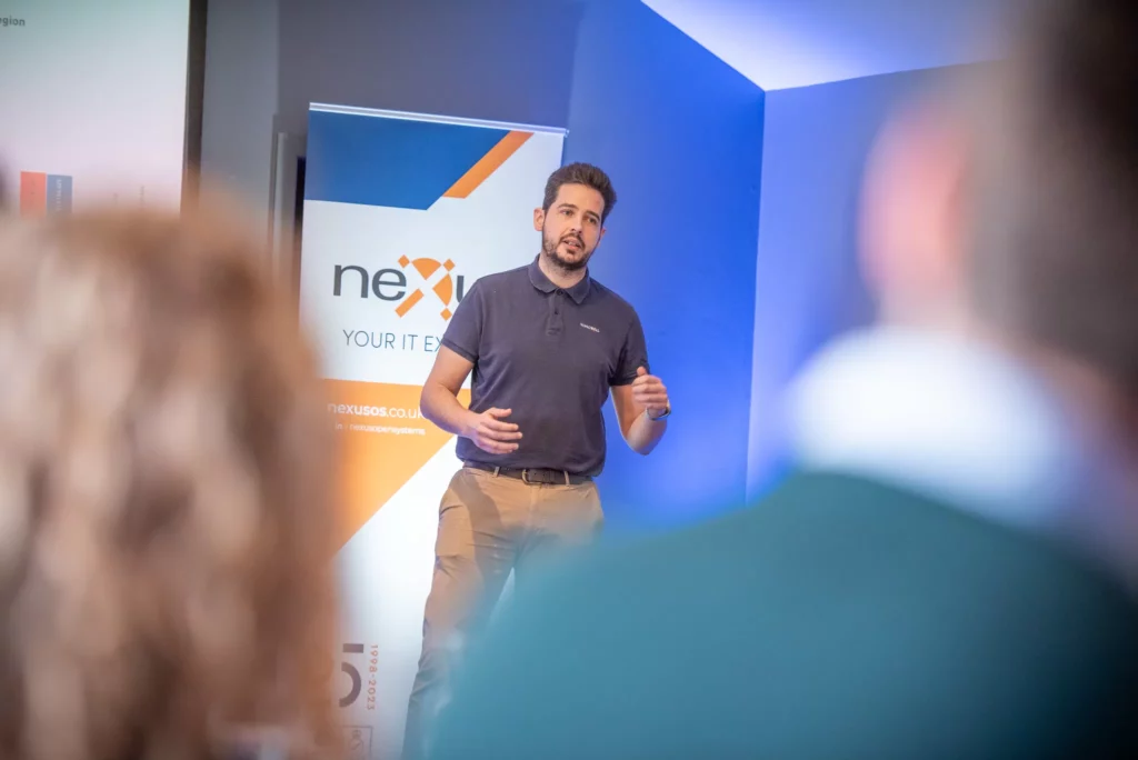 Nexus staff members standing up giving presentation to audience