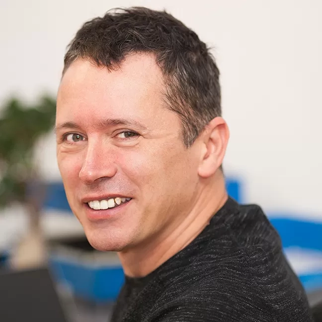 Professional portrait of a Nexus IT Experts team member smiling in the office