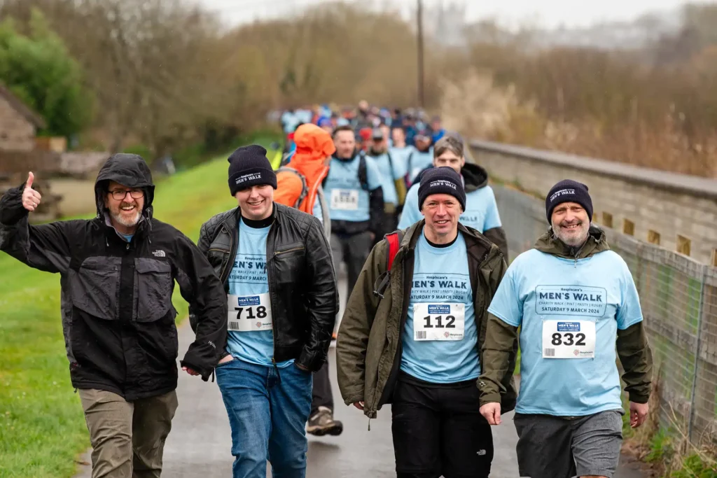 Nexus IT Experts team members taking part in a charity men's walk event, wearing blue event t-shirts and beanies