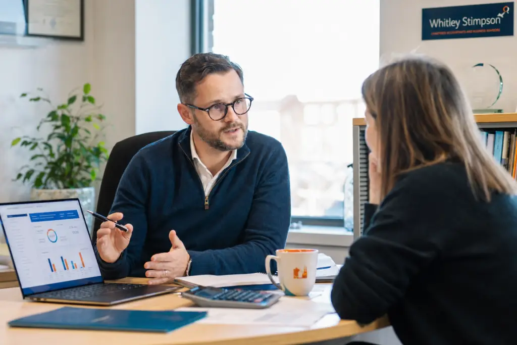 A professional services adviser consults with a customer in a modern office