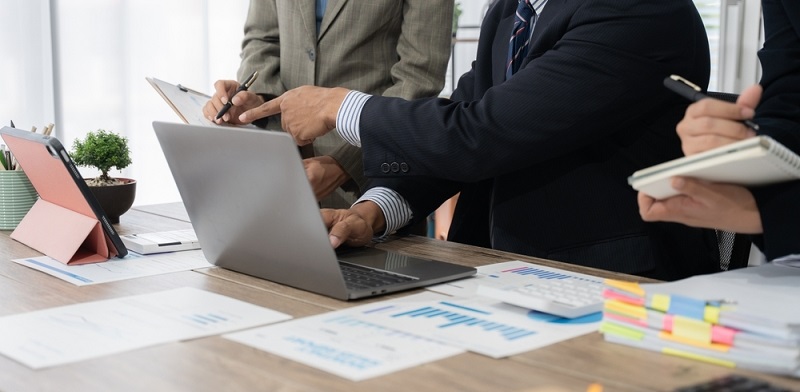 Business Team Collaboration with Laptop and Documents