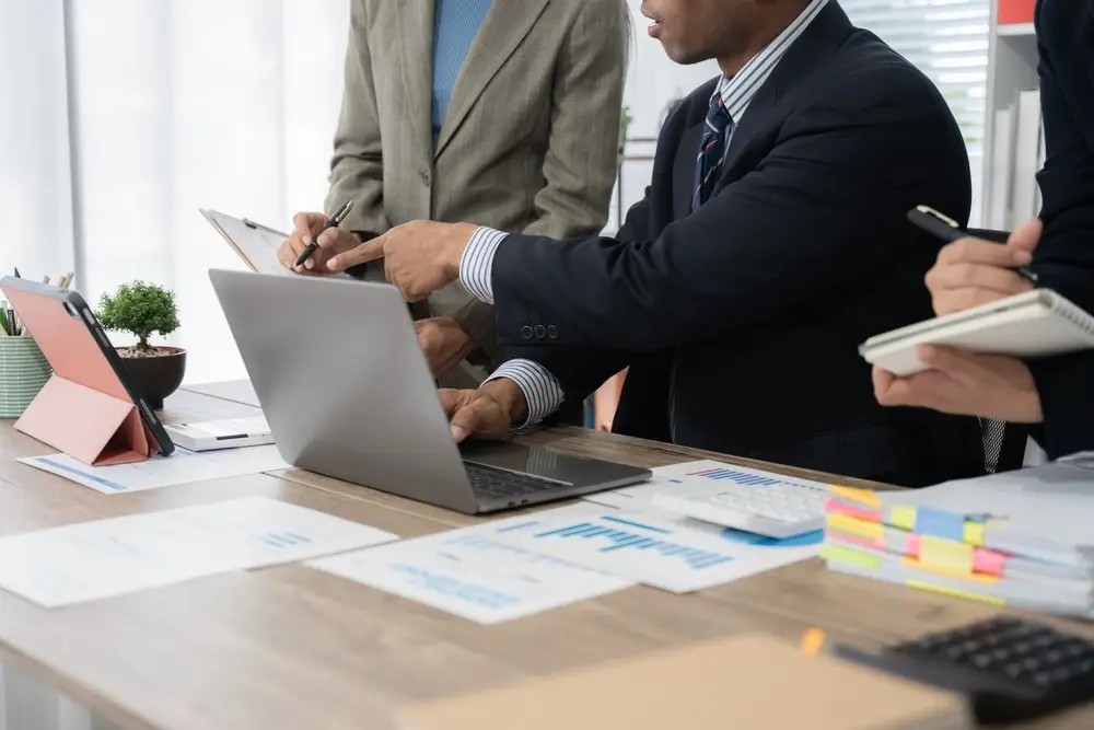 Business Team Collaboration with Laptop and Documents