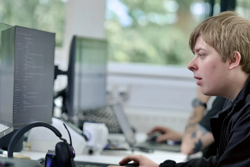 Nexus employee concentrating on coding or IT tasks at a desk
