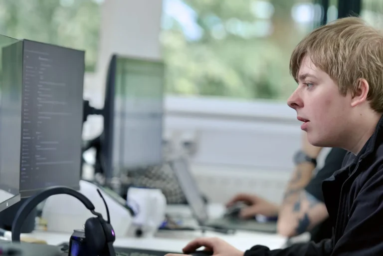 Nexus employee concentrating on coding or IT tasks at a desk