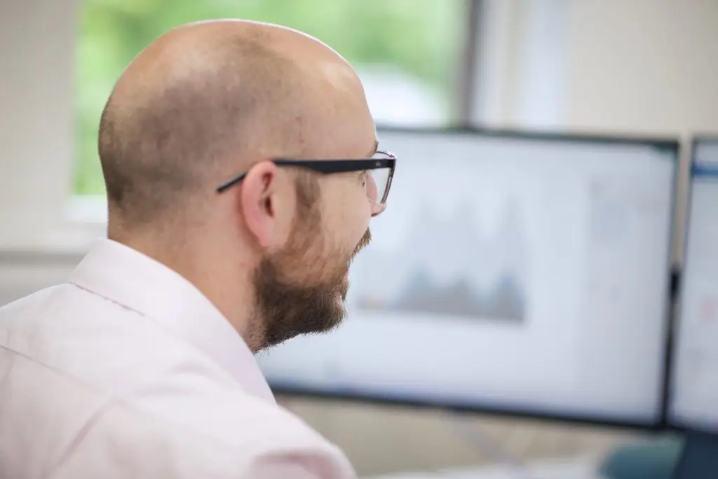 A Nexus staff member reviews graphical data