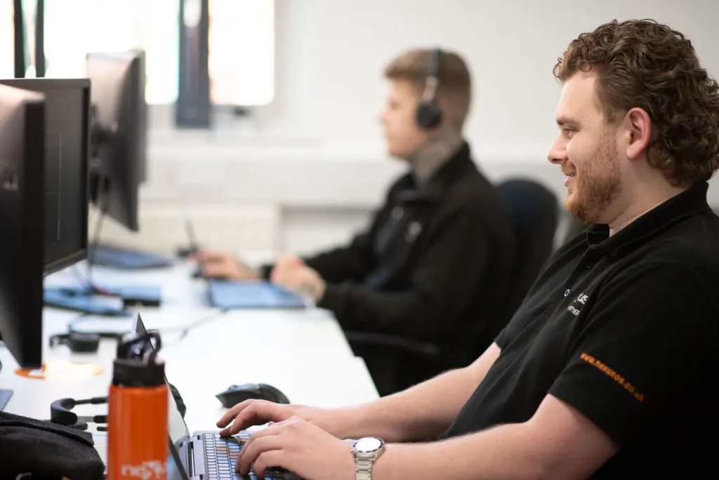 Two Nexus IT support team members focusing on client support tasks.