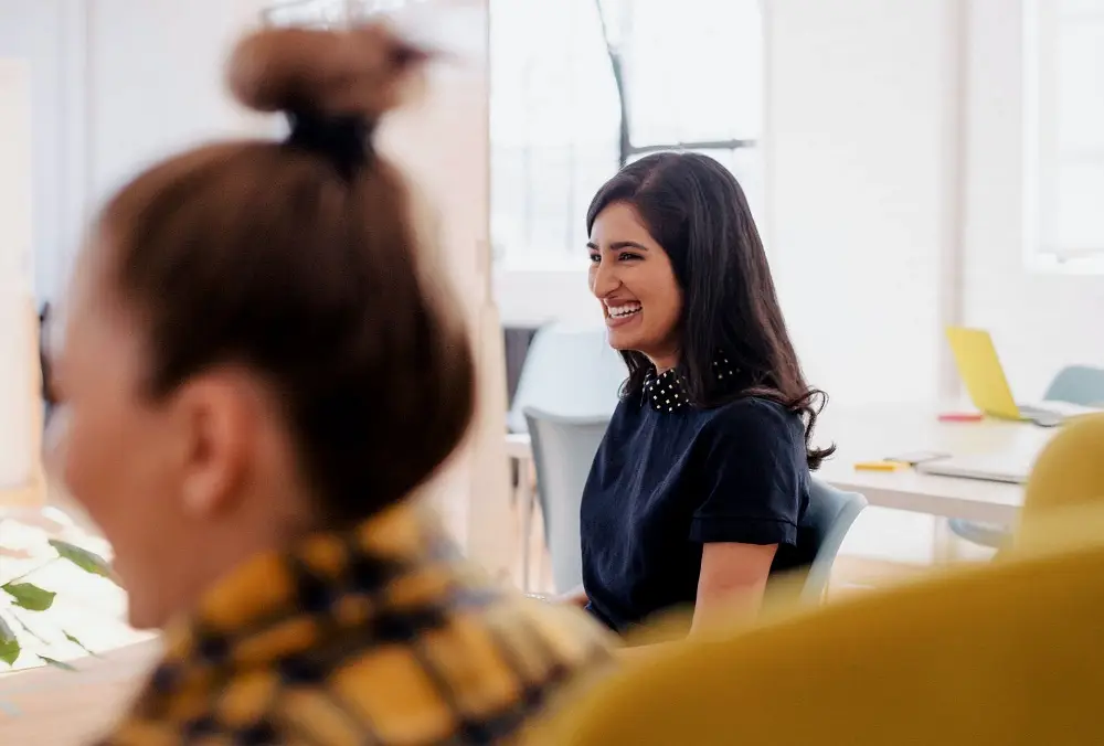 Woman smiling in office meeting